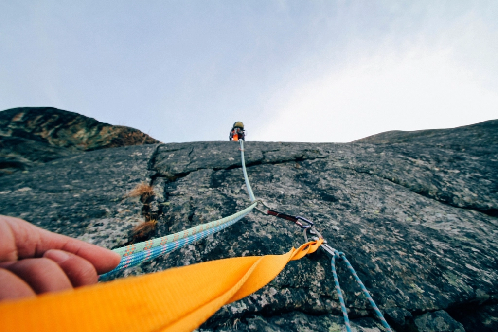 Free people climbing mountain cliff